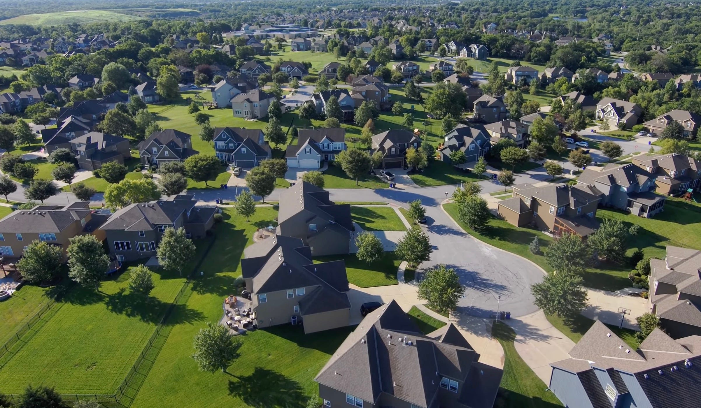 Image: _American Suburb - Image from video by David McBee -[pexels.com](https://www.pexels.com/video/drone-footage-of-a-neighborhood-5031099/)_